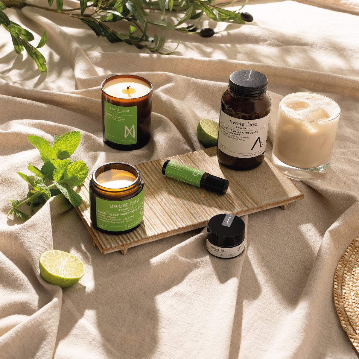 Summer Stillness candle, Sweet Sleep, calming roller and Radiant Tremella Infusion on summer linen