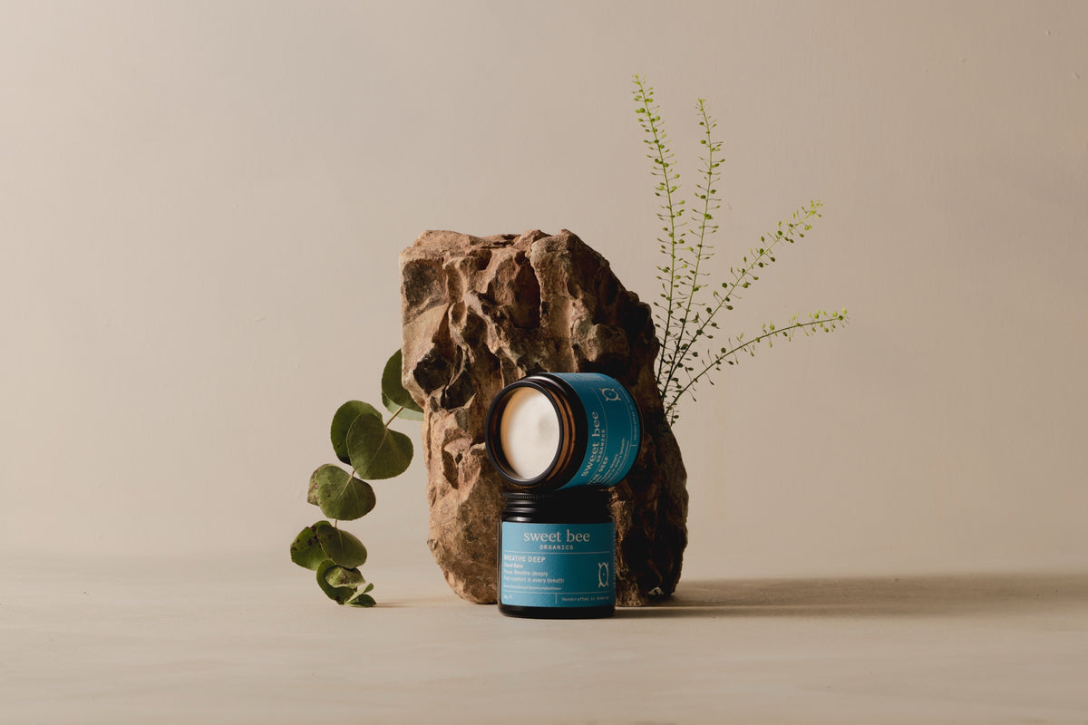 Open jar of Breathe Deep Cloud Balm showing the whipped white balm, with fresh eucalyptus